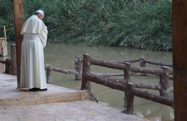 Pope Francis prays at the Jordan River in the wilderness of Bethany-beyond-the-Jordan, the very area where Jesus came to be baptized before beginning his public ministry.